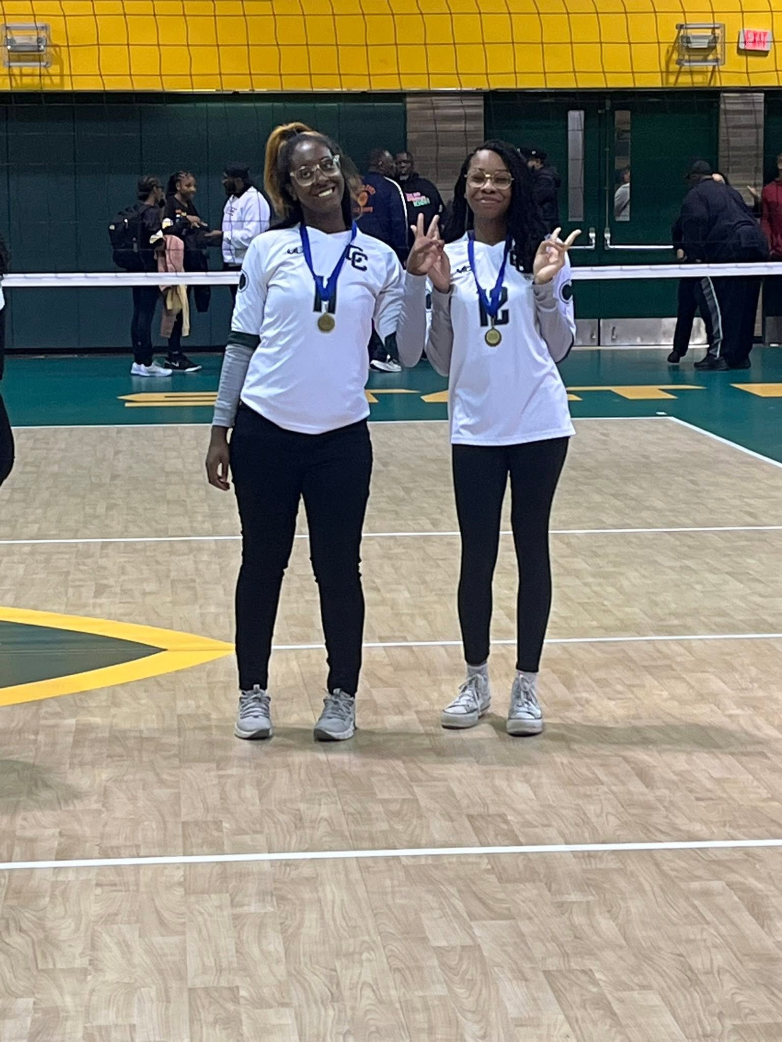 Hardware and smiles with a Lady Comets teammate